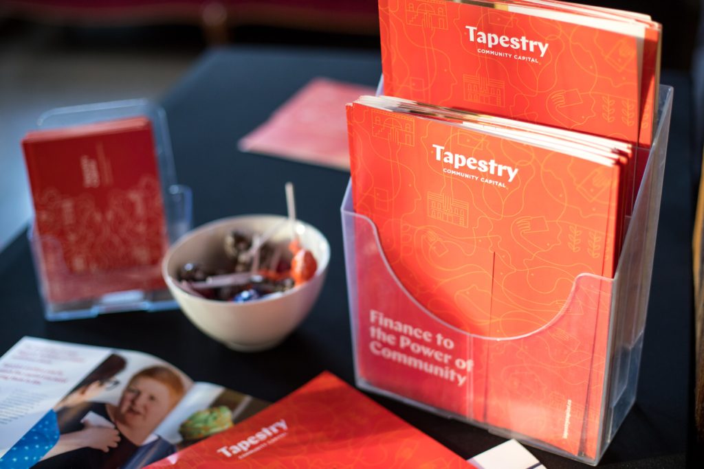 Tapestry promotional materials on a table